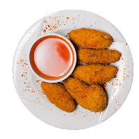 Five breaded chicken nuggets arranged on a white plate with a small bowl of red dipping sauce.